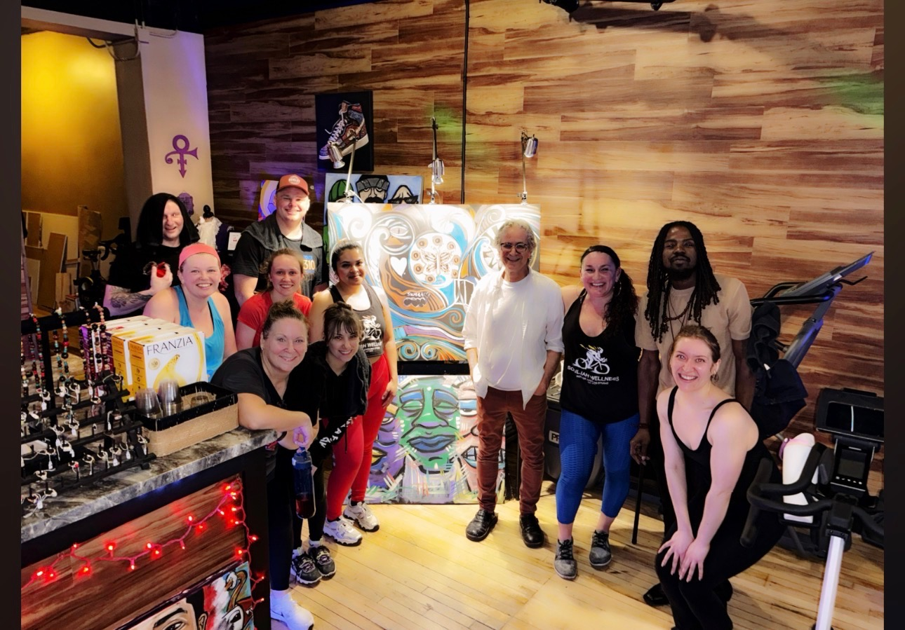 Collaborative painting on display at an event, ready to be taken to the office